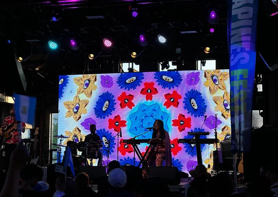 Colorful video wall displaying graphics behind performers